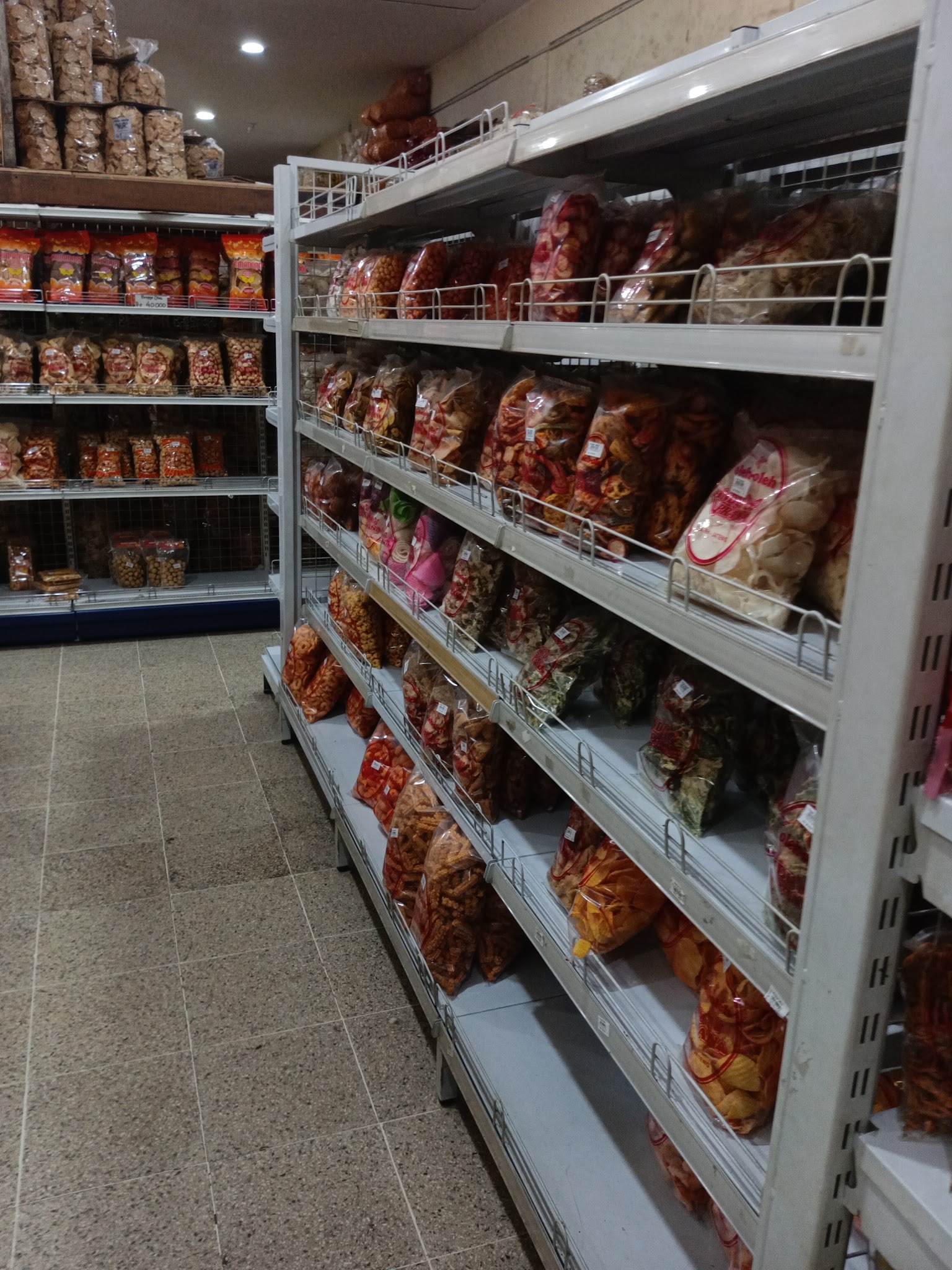 Aisle of packaged snacks inside an Andu Prana shop